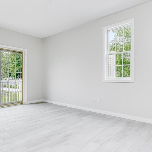 Wide open living areas perfect for entertaining a room with a wood floor and and windows