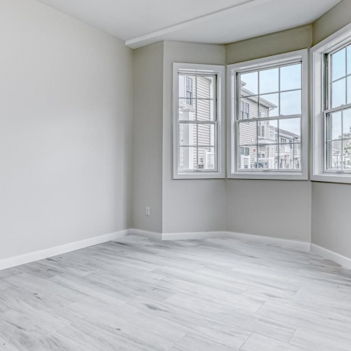 Relax and recharge in beautiful and spacious bedrooms a room with a wood floor and windows